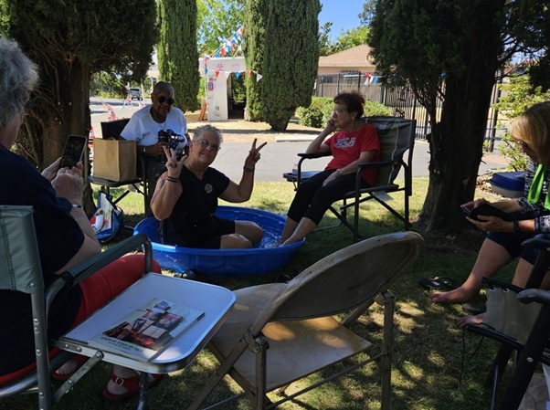 photo of the Fireworks Booth volunteers trying to cool down in 2024